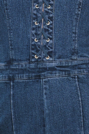 Close-up of a blue denim jumpsuit with lace-up front | Flying Tomato