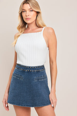 Woman wearing a blue denim skort with studded eyelet waistband denim skort | Flying Tomato