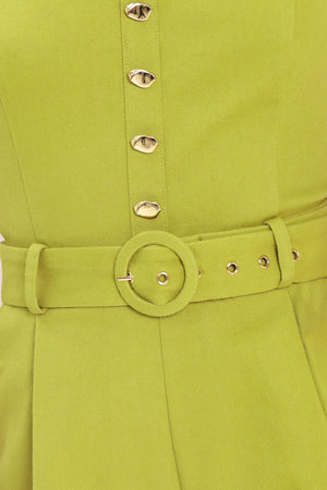 Woman wearing a green romper with buttons and a belt | Flying Tomato