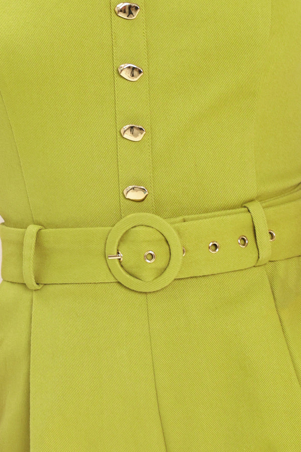Woman wearing a green romper with buttons and a belt | Flying Tomato