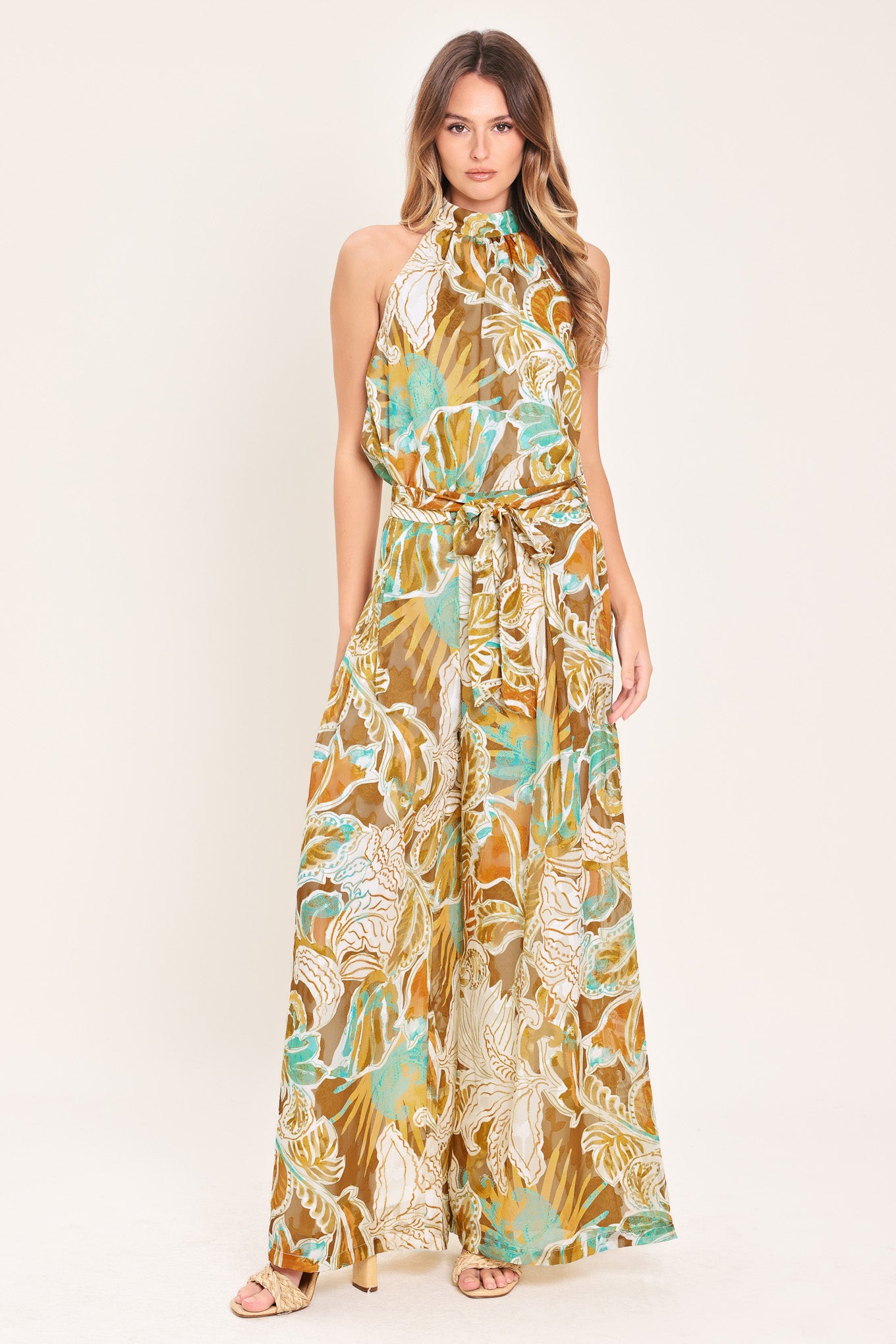 Woman wearing tropical brown, teal, and yellow patterned wide-leg pants | Flying Tomato