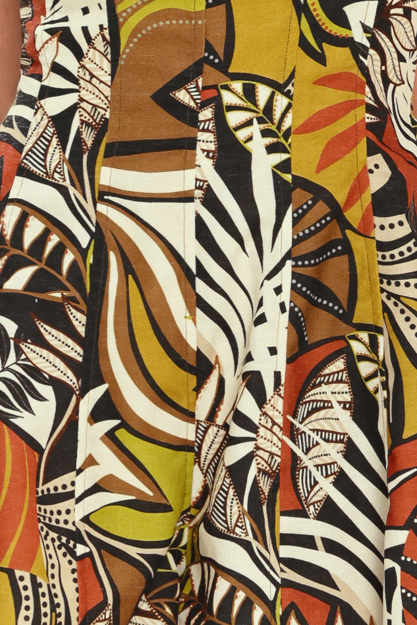 Close-up of a colorful fabric with abstract patterns including zebra stripes and tribal designs | Flying Tomato