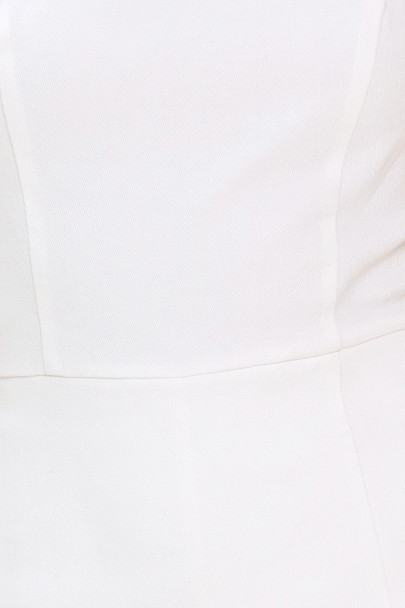 Close-up of a white dress with a fitted bodice and flared skirt | Flying Tomato