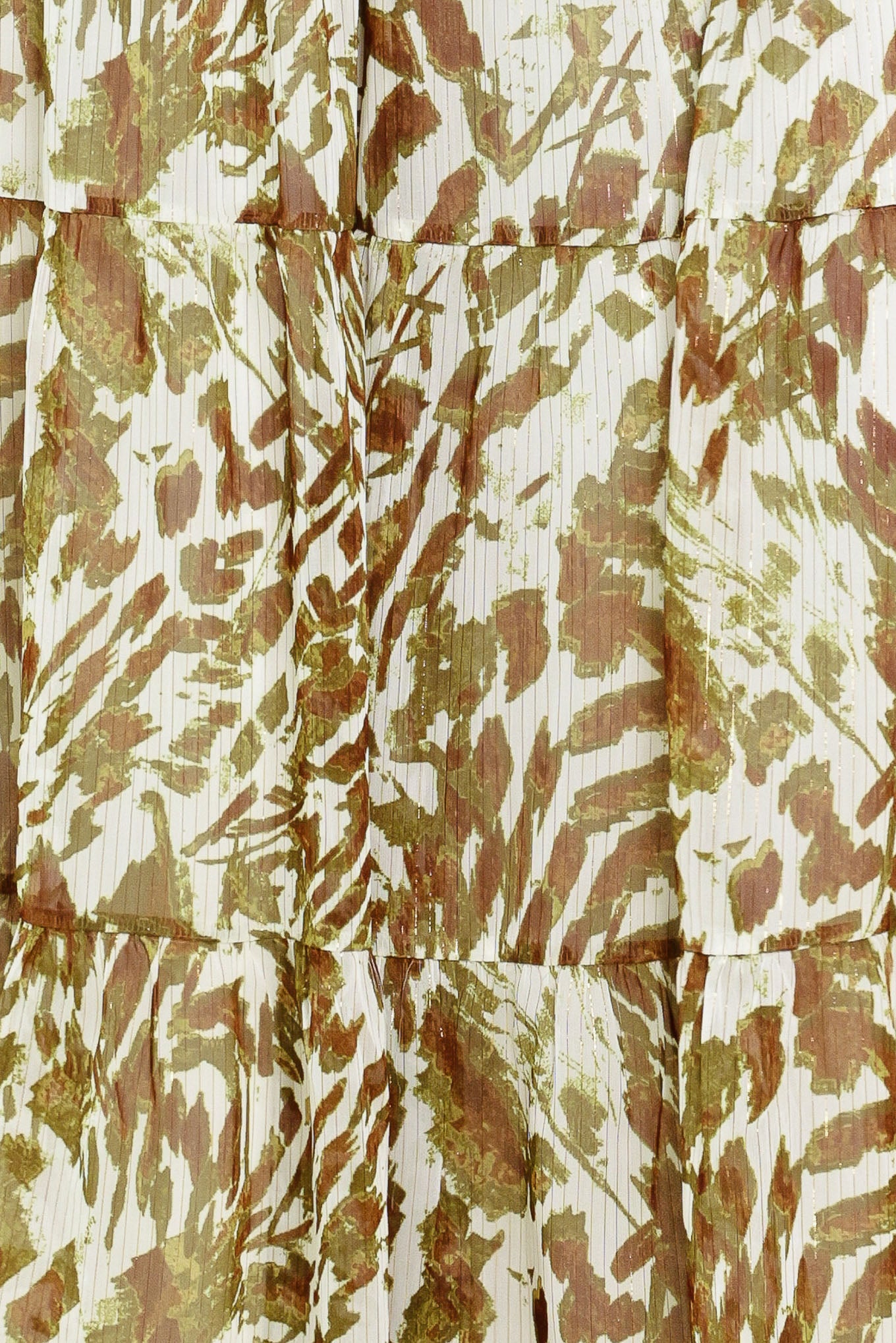 Woman wearing an olive green, brown, and white patterned woven jumpsuit featuring round neckline, short sleeve, front tie detail, elastic waist and tier wide leg pant | Flying Tomato