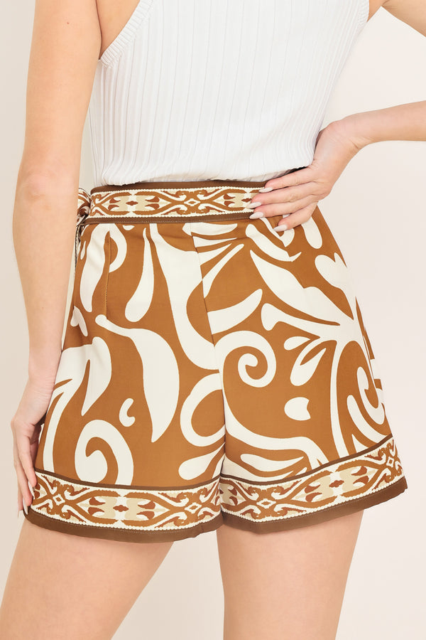 Woman wearing a brown and white patterned skort with a tie waist | Flying Tomato