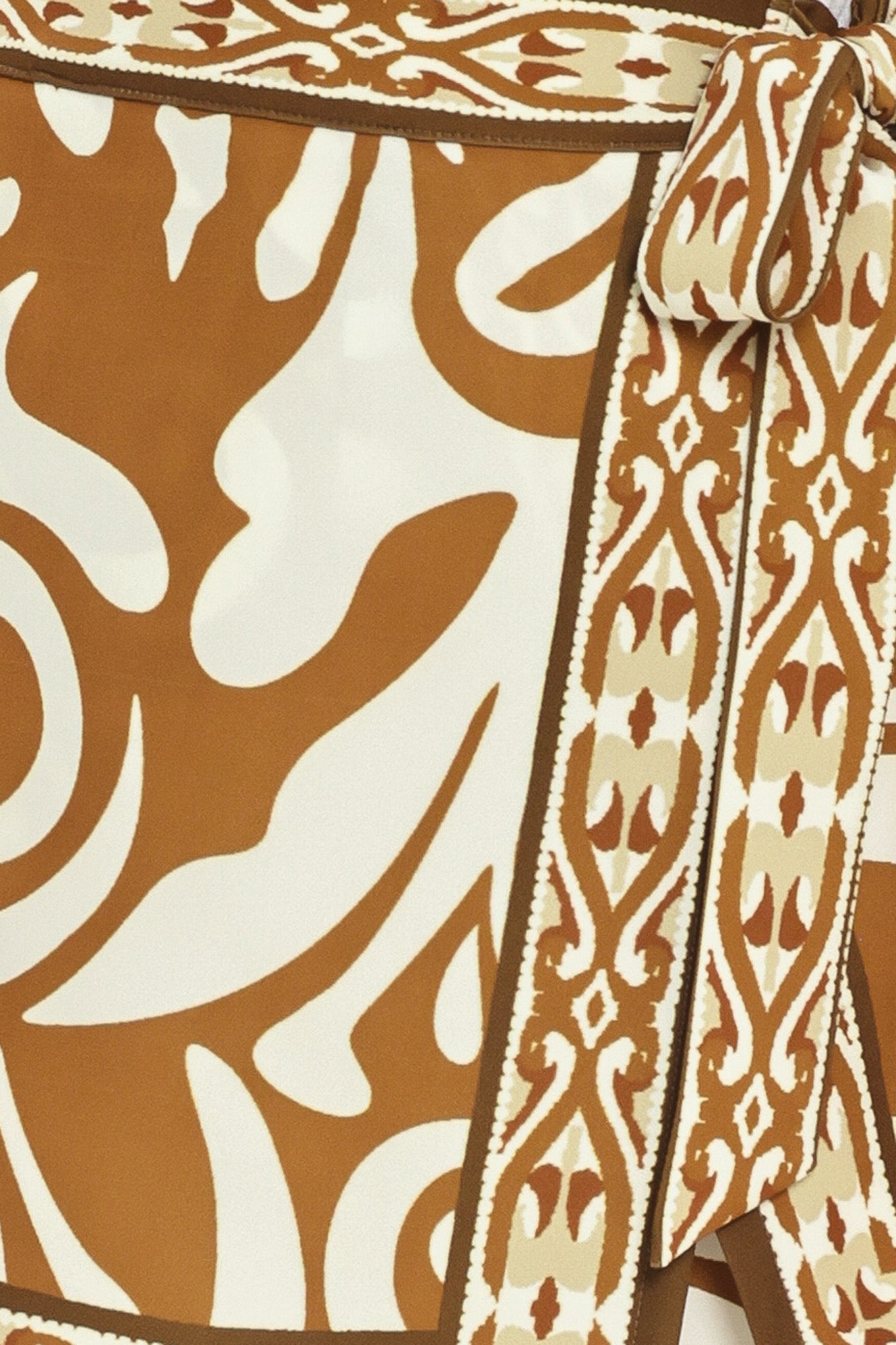 Woman wearing a brown and white patterned skort with a tie waist | Flying Tomato