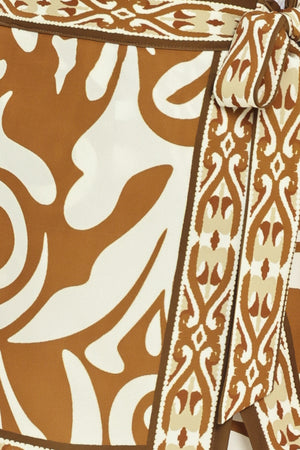 Woman wearing a brown and white patterned skort with a tie waist | Flying Tomato
