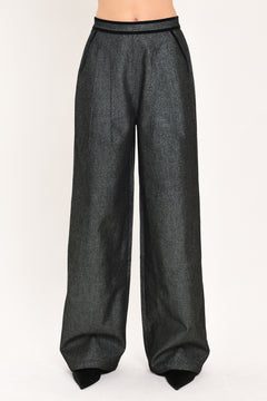 A pair of wide-leg trousers in a black denim textured fabric, shown on a model | Flying Tomato