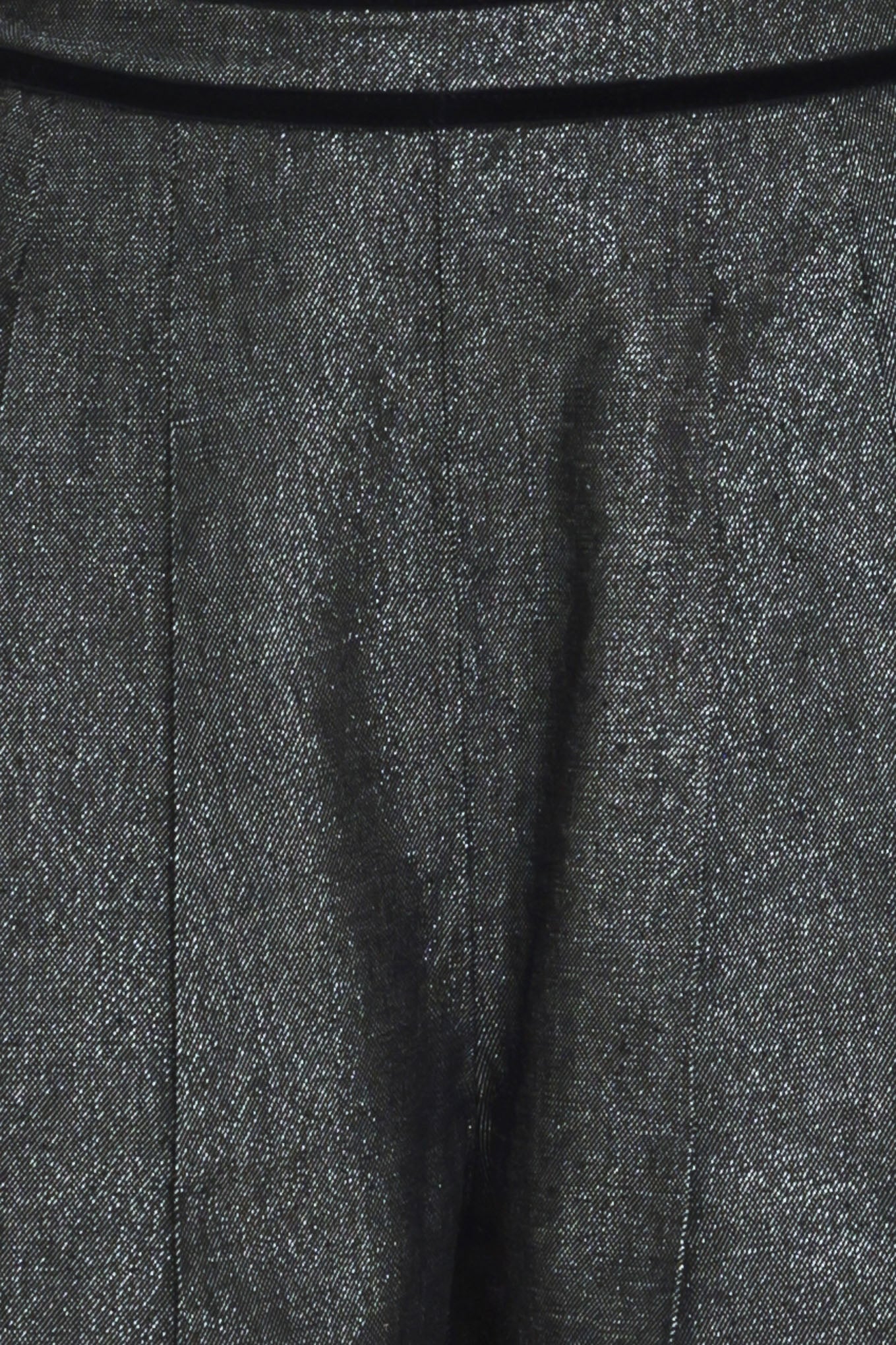 A pair of wide-leg trousers in a black denim textured fabric, shown on a model | Flying Tomato