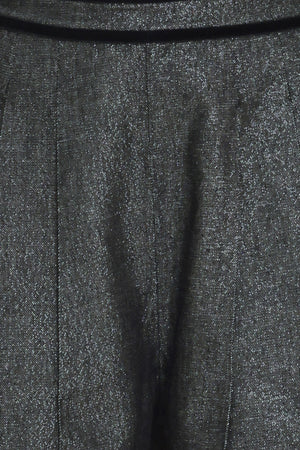 A pair of wide-leg trousers in a black denim textured fabric, shown on a model | Flying Tomato