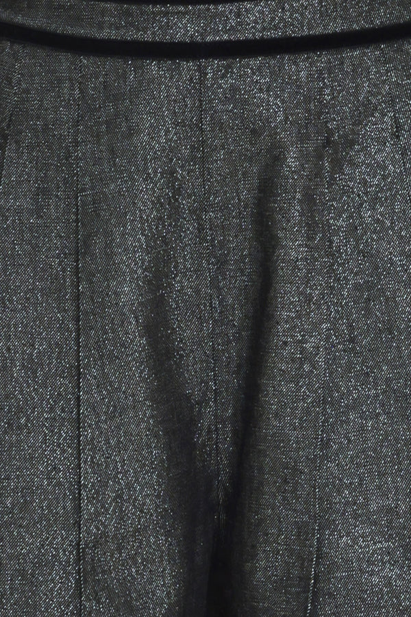 A pair of wide-leg trousers in a black denim textured fabric, shown on a model | Flying Tomato