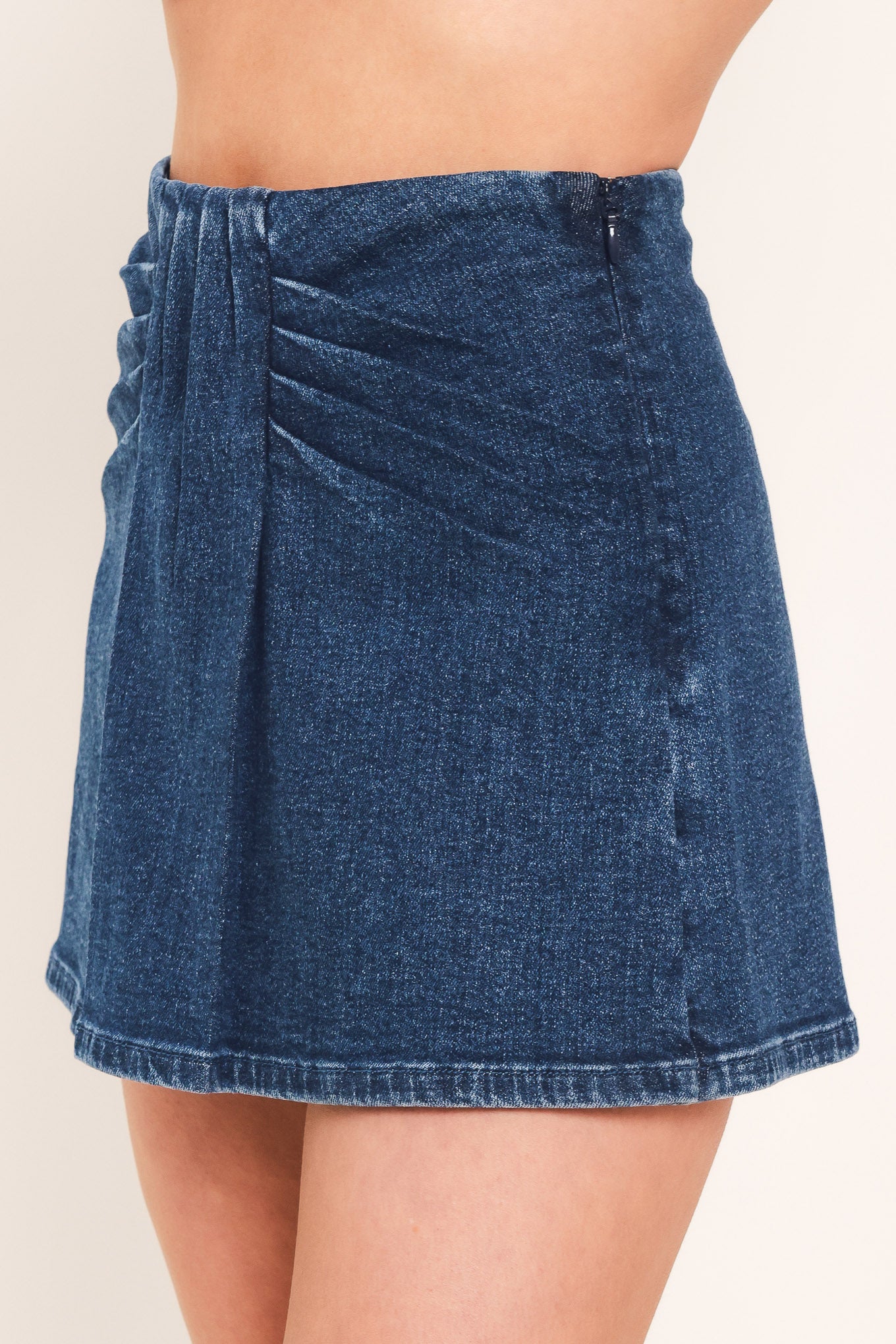 A woman wearing a dark blue denim mini skort | Flying Tomato