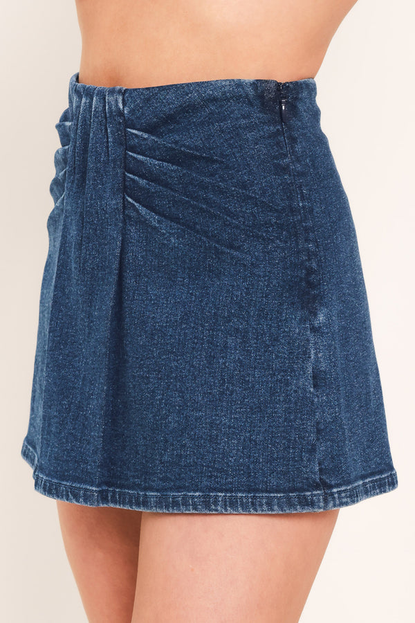 A woman wearing a dark blue denim mini skort | Flying Tomato