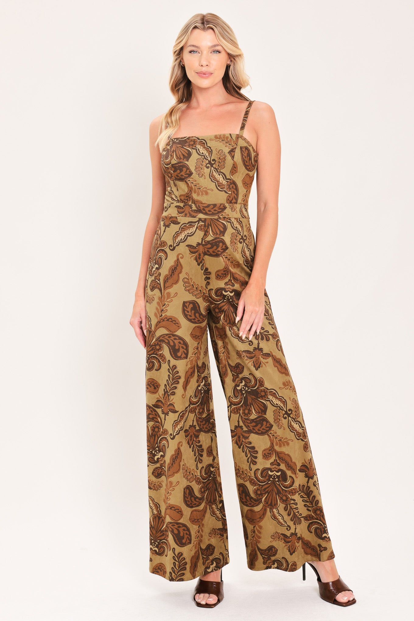 A woman modeling a sleeveless wide-leg jumpsuit with a brown and tan paisley pattern | Flying Tomato