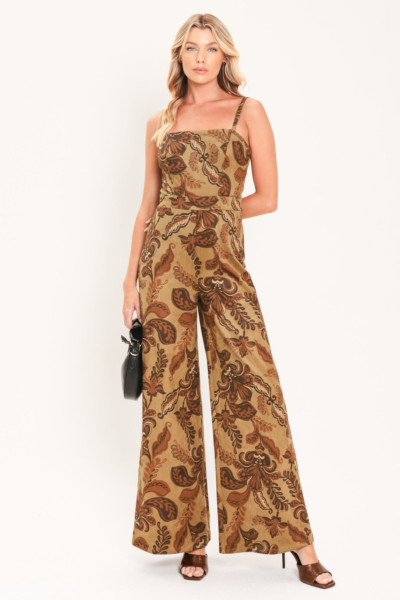 A woman modeling a sleeveless wide-leg jumpsuit with a brown and tan paisley pattern | Flying Tomato