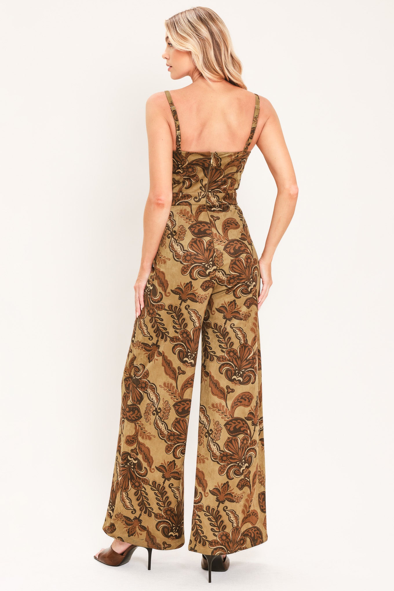 A woman modeling a sleeveless wide-leg jumpsuit with a brown and tan paisley pattern | Flying Tomato