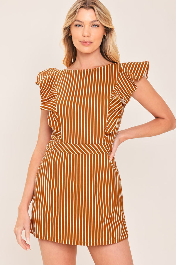 A woman wearing a mini skort romper with vertical rust and white stripes | Flying Tomato