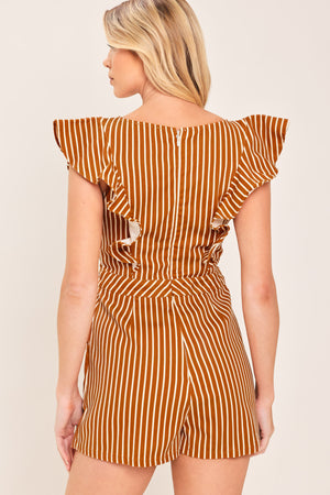A woman wearing a mini skort romper with vertical rust and white stripes | Flying Tomato