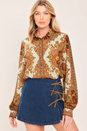 A woman wearing a blue denim mini skort featuring lace-up details on the side | Flying Tomato