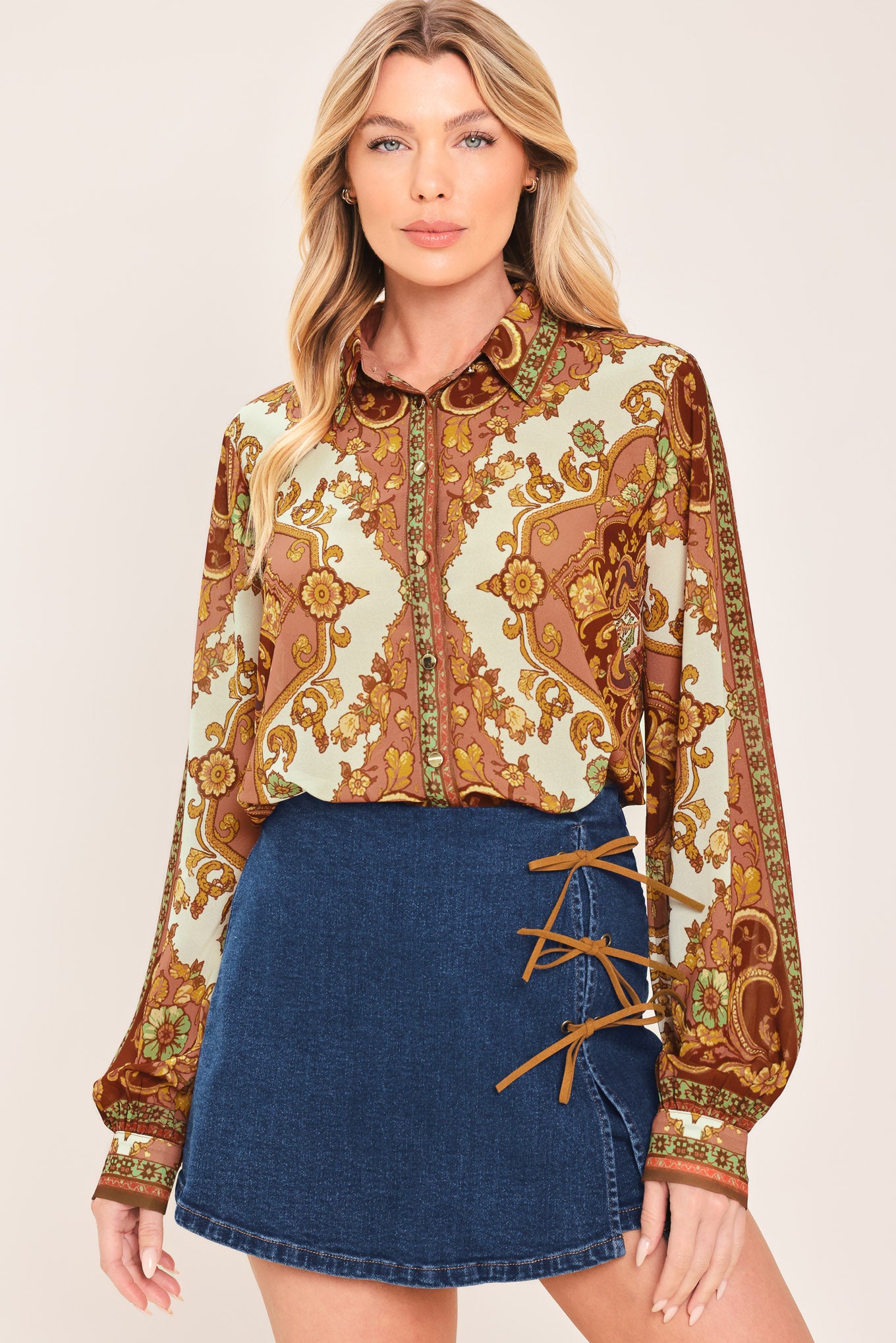 A woman wearing a blue denim mini skort featuring lace-up details on the side | Flying Tomato