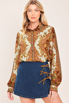 A woman wearing a blue denim mini skort featuring lace-up details on the side | Flying Tomato