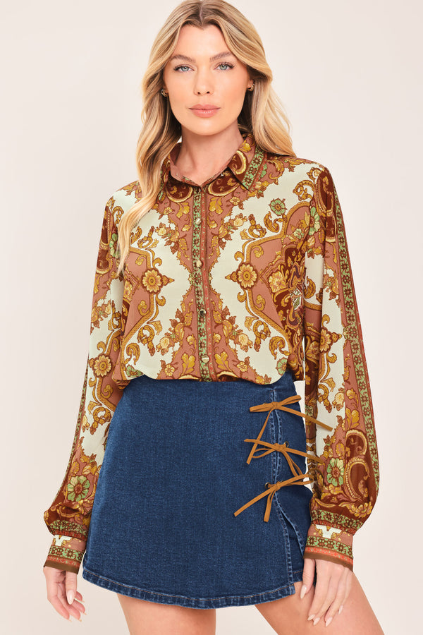 A woman wearing a blue denim mini skort featuring lace-up details on the side | Flying Tomato