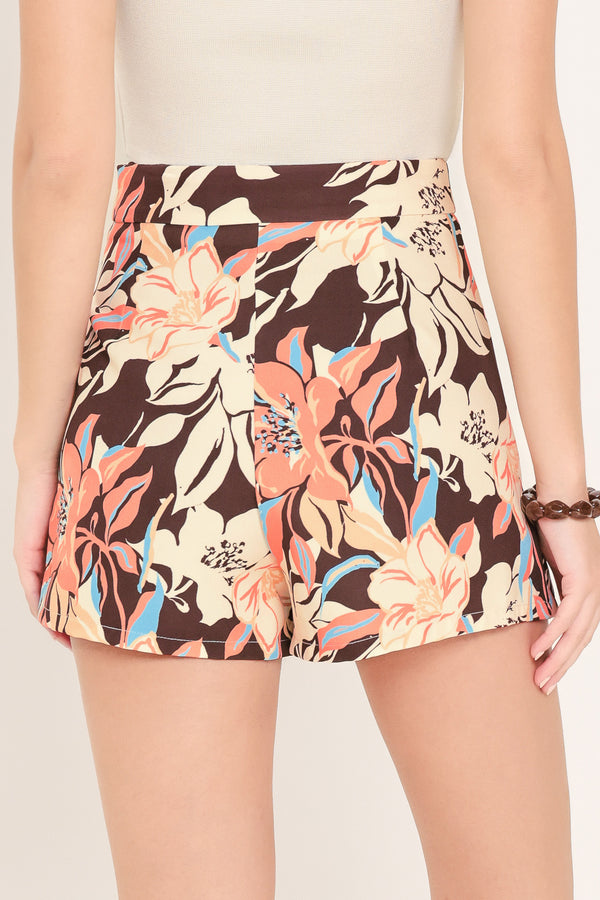 Woman wearing a floral patterned dark brown skort | Flying Tomato