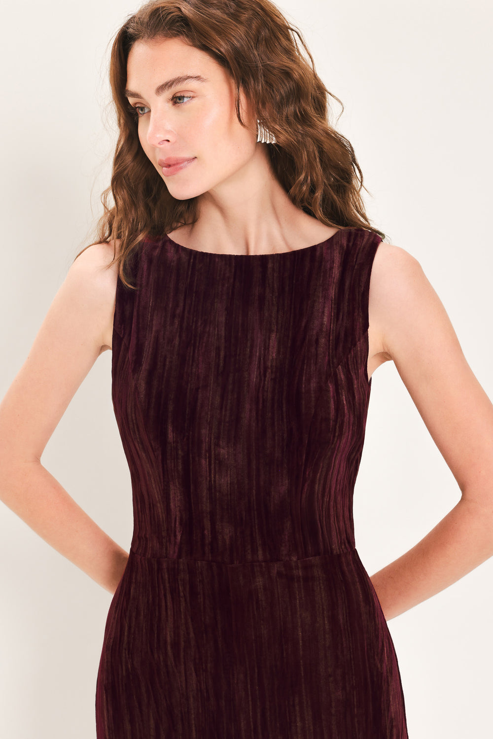Woman wearing a sleeveless burgundy velvet jumpsuit with wide-leg pants | Flying Tomato