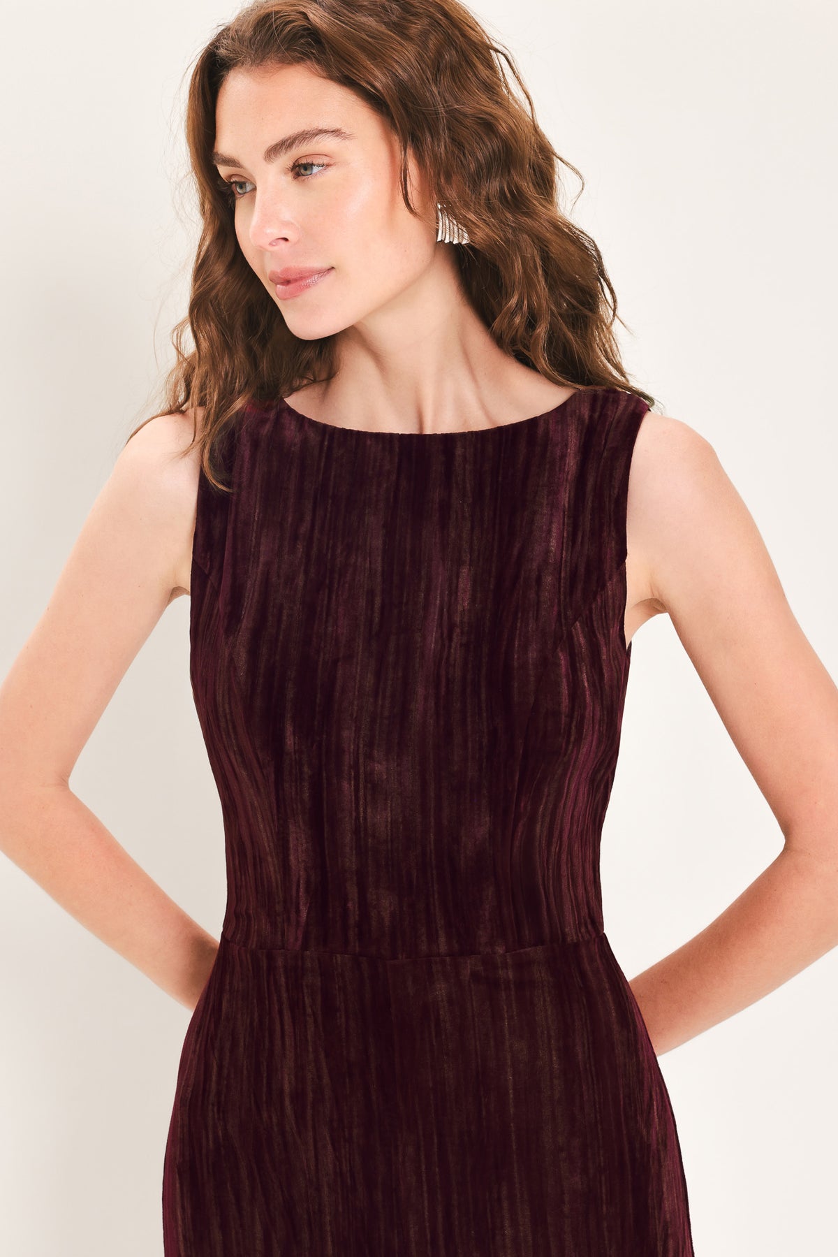Woman wearing a sleeveless burgundy velvet jumpsuit with wide-leg pants | Flying Tomato