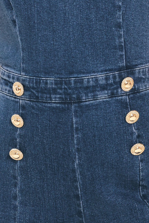 Woman wearing a denim jumpsuit featuring halter neckline, front button detail, wide leg, bare back and zipper closure | Flying Tomato