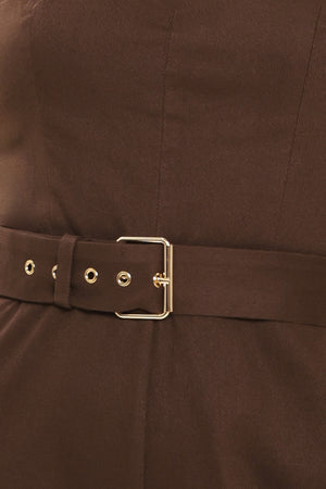 Woman wearing a brown solid woven jumpsuit featuring sweetheart neckline, straps, self belt, wide leg and back zipper closure | Flying Tomato