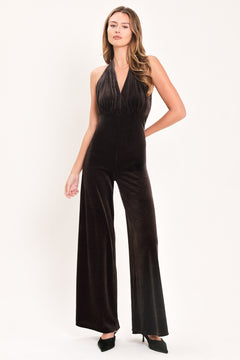 Woman wearing a brown velvet halter, backless jumpsuit | Flying Tomato