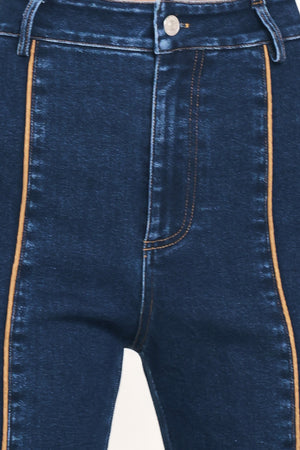 A model wearing dark blue high-waisted flare jeans with distinctive gold-colored contrast stitching running down the center of the legs | Flying Tomato