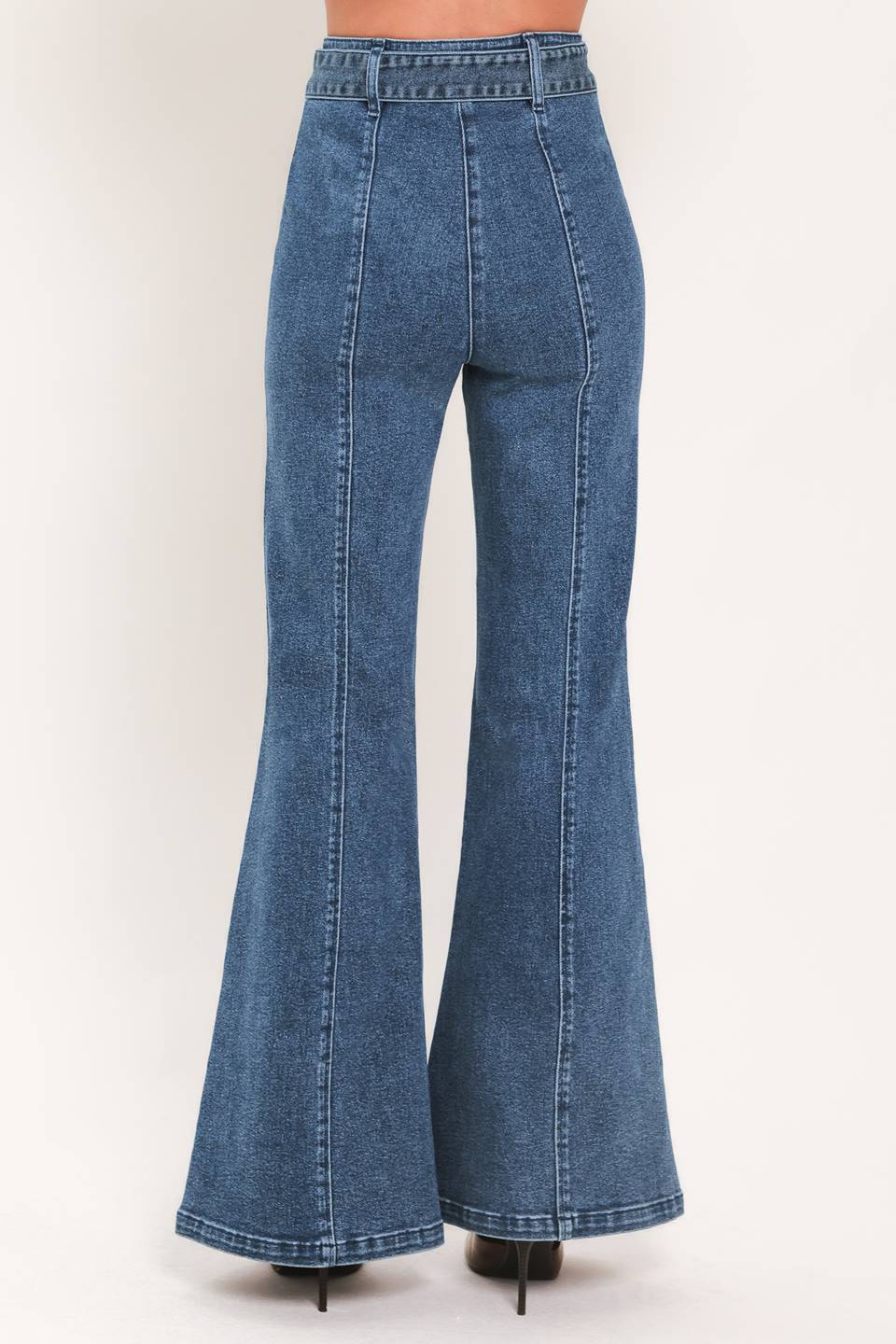 A woman wearing blue high-waisted flare jeans with front flap pockets and gold-tone button details | Flying Tomato