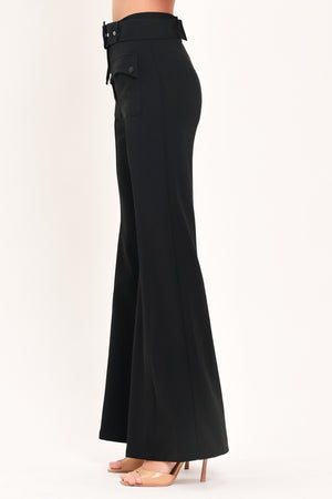 Woman wearing a pair of black pants with a belt and front pockets | Flying Tomato