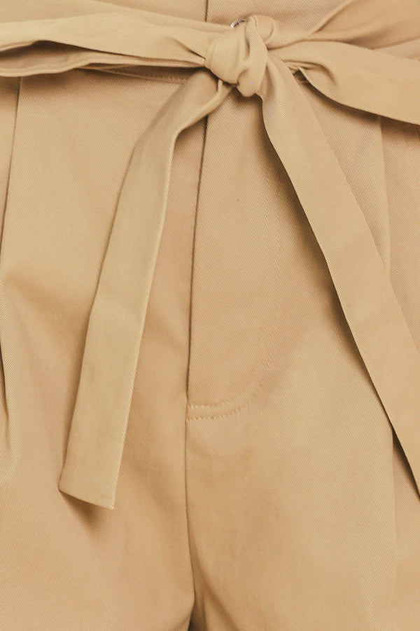 Woman wearing a taupe beige high waisted shorts with a self tie matching belt | Flying Tomato