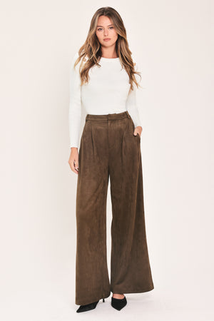 A person wearing high-waisted, wide-leg brown suede pants | Flying Tomato