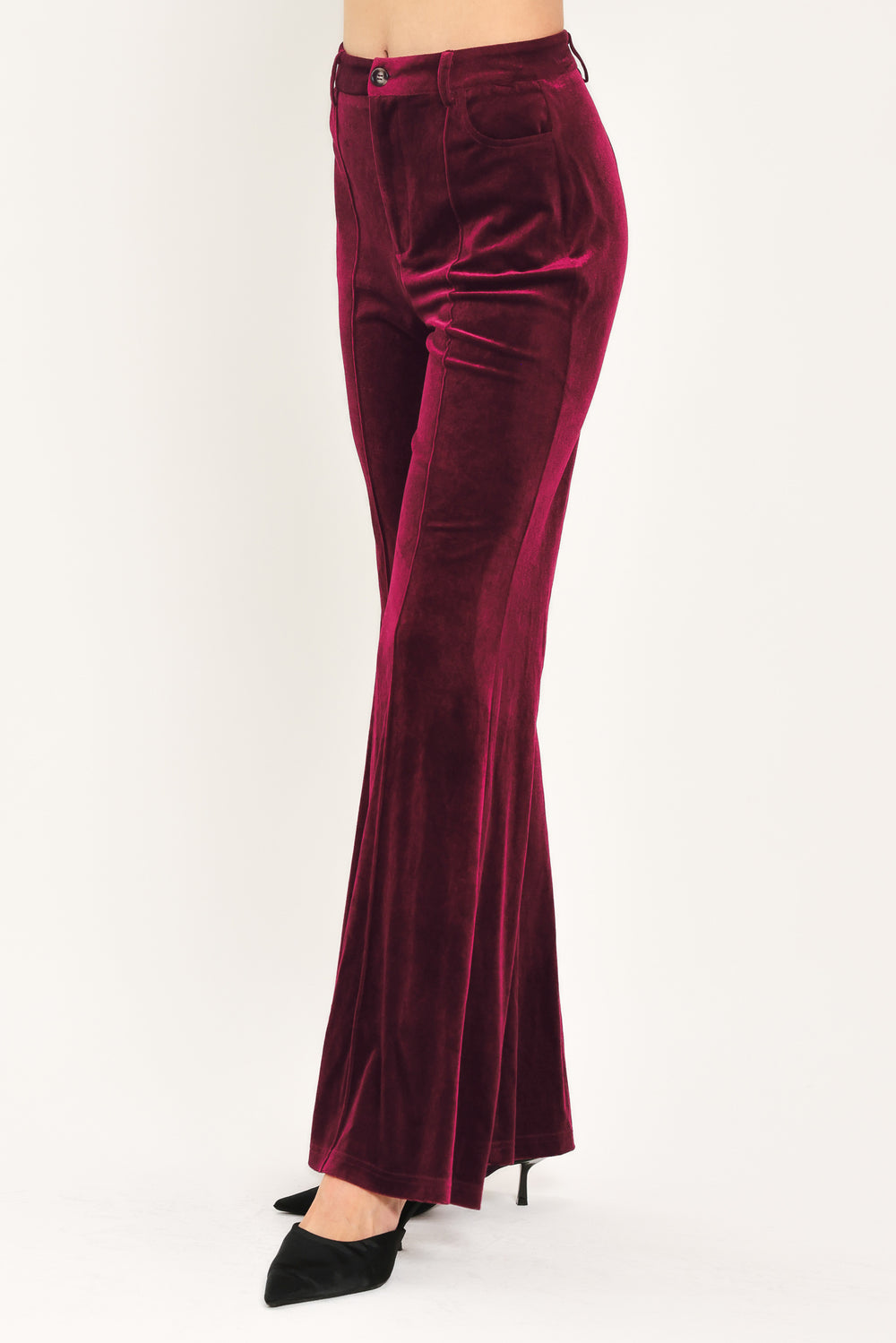 A pair of high-waisted, wide-leg velvet pants in a deep burgundy red, shown on a model | Flying Tomato