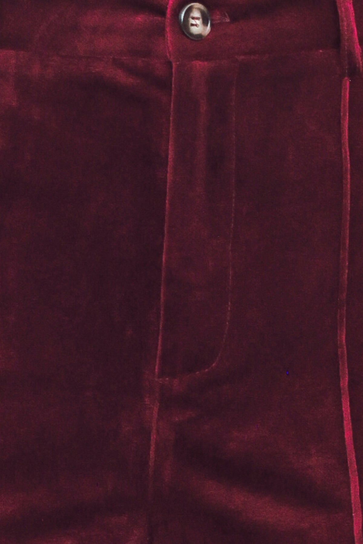 A pair of high-waisted, wide-leg velvet pants in a deep burgundy red, shown on a model | Flying Tomato