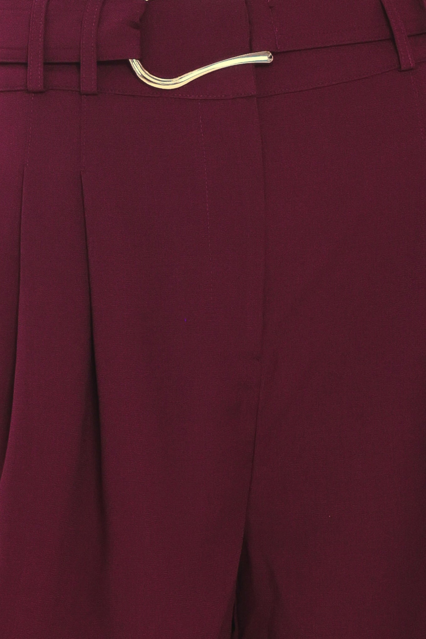 A model wearing high-waisted, wide-leg cropped trousers in deep burgundy with pleats and a matching belt | Flying Tomato