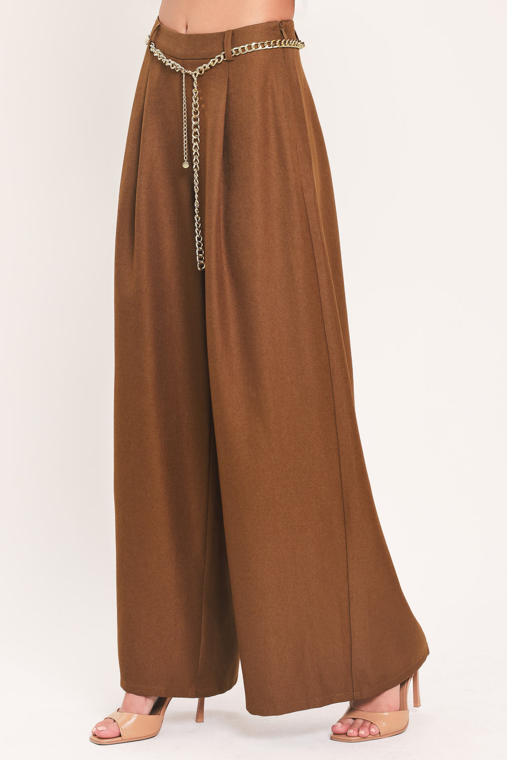 A person wearing high-waisted, wide-leg brown pants with a decorative gold chain belt detail at the waist | Flying Tomato