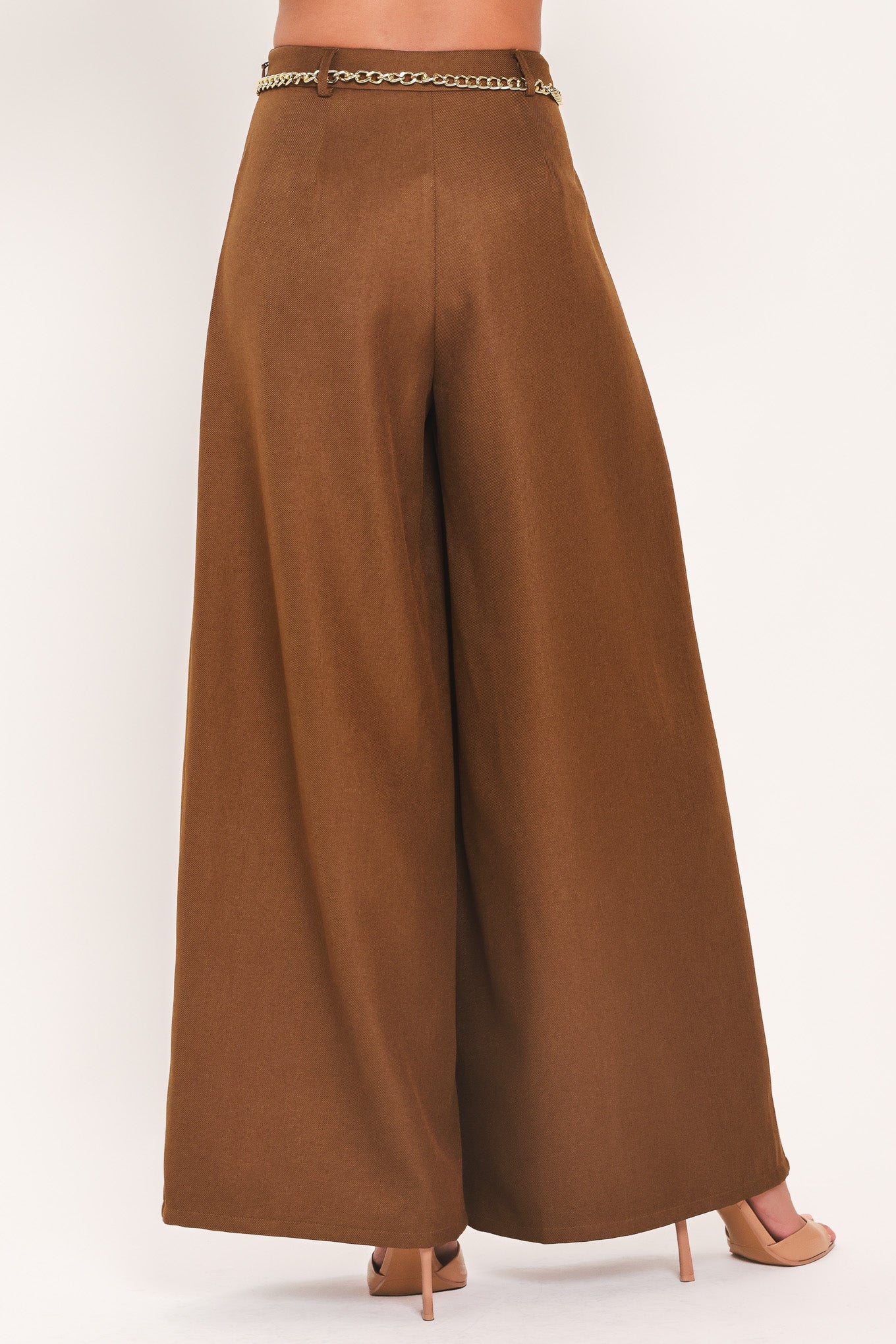 A person wearing high-waisted, wide-leg brown pants with a decorative gold chain belt detail at the waist | Flying Tomato