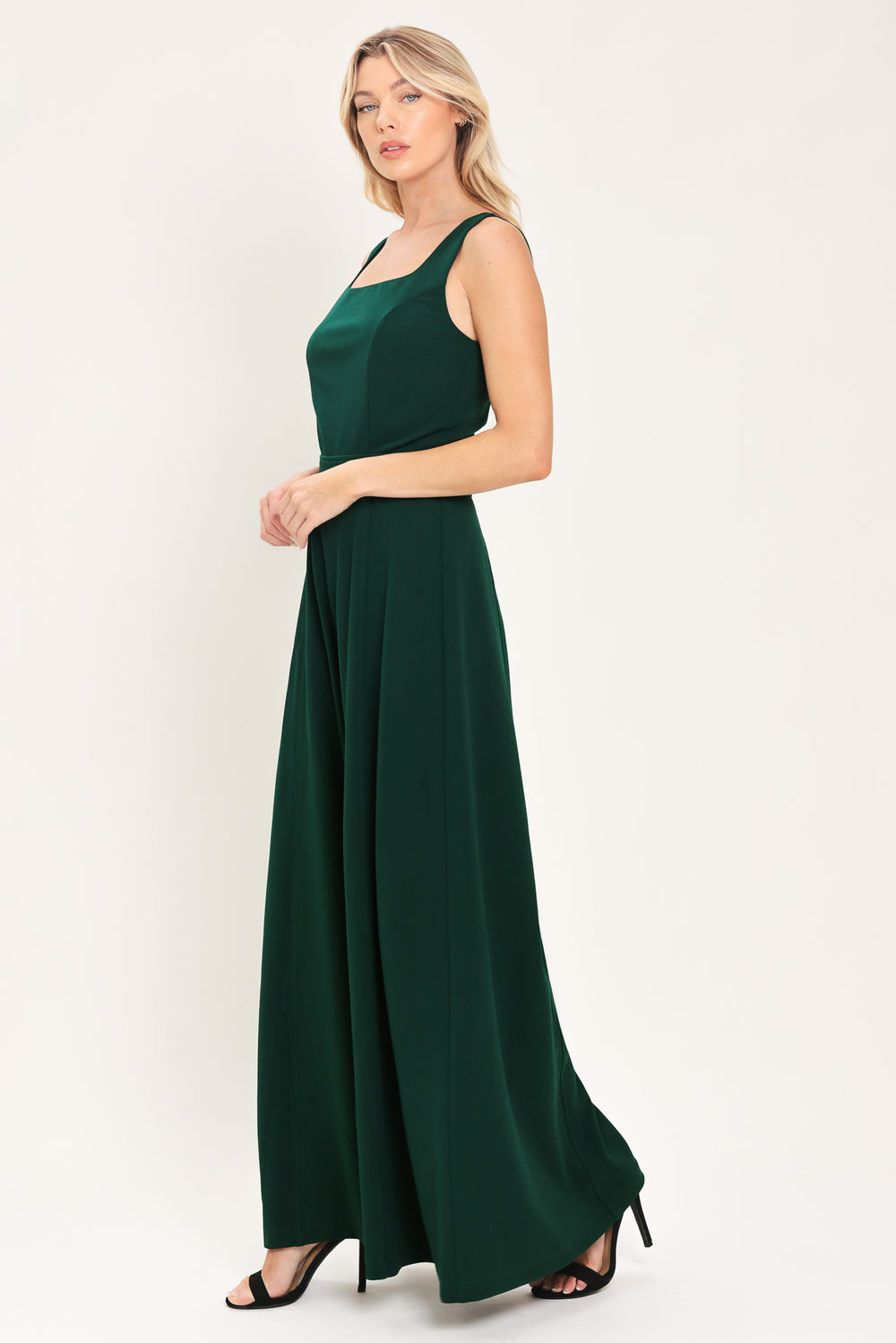 Woman wearing a sleeveless square neck solid hunter green wide-leg jumpsuit | Flying Tomato