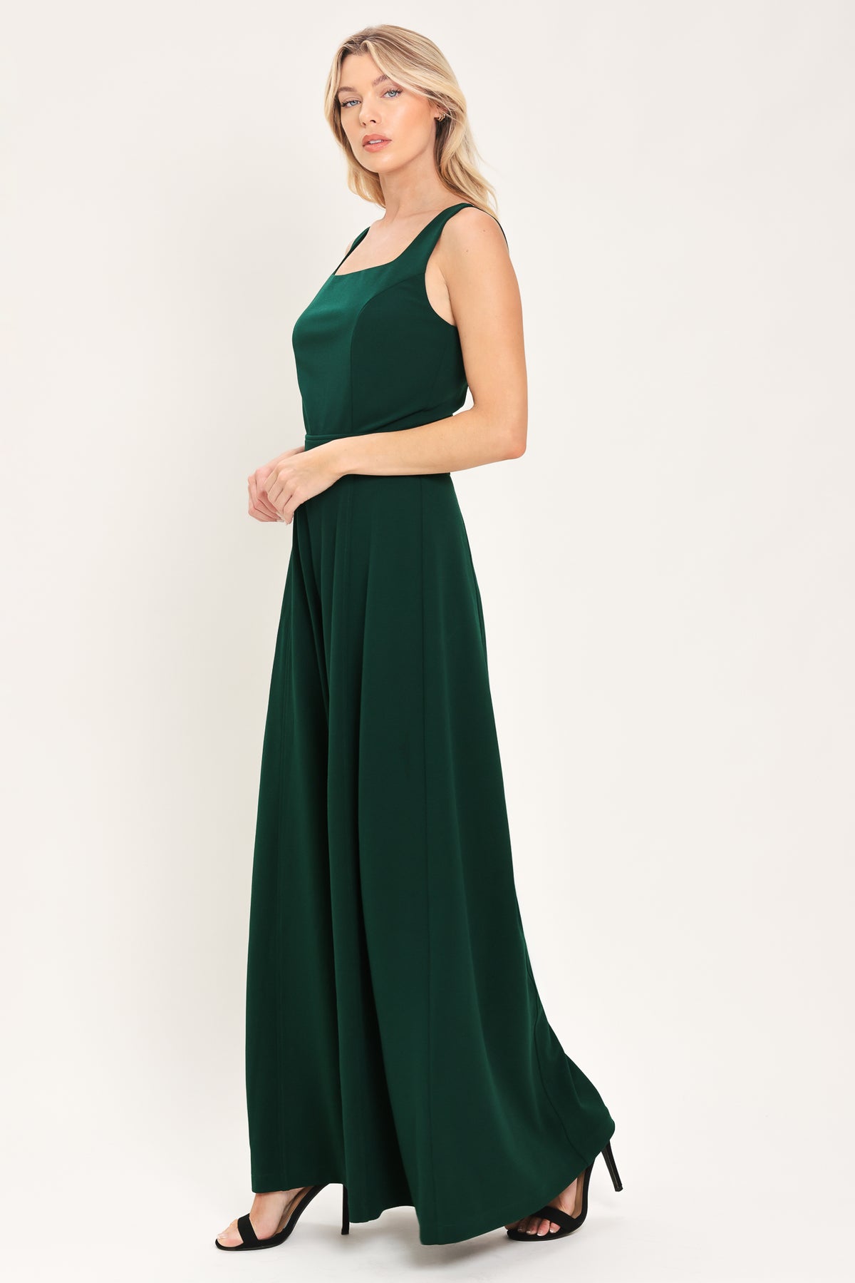 Woman wearing a sleeveless square neck solid hunter green wide-leg jumpsuit | Flying Tomato