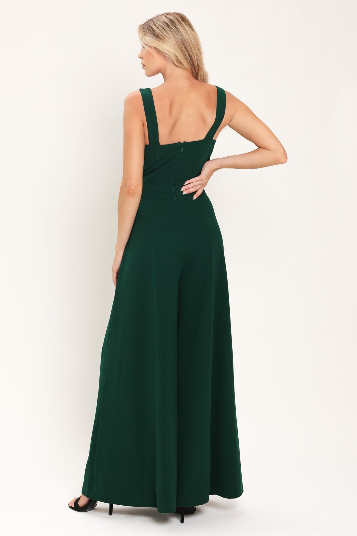 Woman wearing a sleeveless square neck solid hunter green wide-leg jumpsuit | Flying Tomato