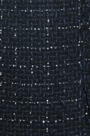 A woman modeling a navy blue tweed mini skort with subtle silver and white speckles | Flying Tomato