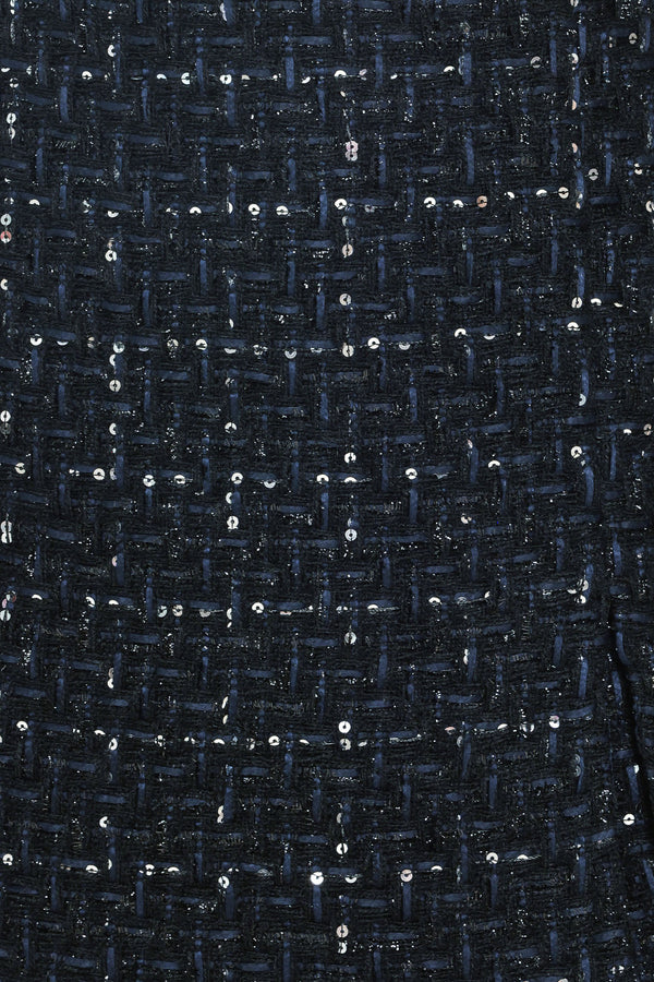A woman modeling a navy blue tweed mini skort with subtle silver and white speckles | Flying Tomato