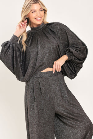 A pair of dark gray metallic wide-leg harem pants with elastic cuffs, shown on a model | Flying Tomato