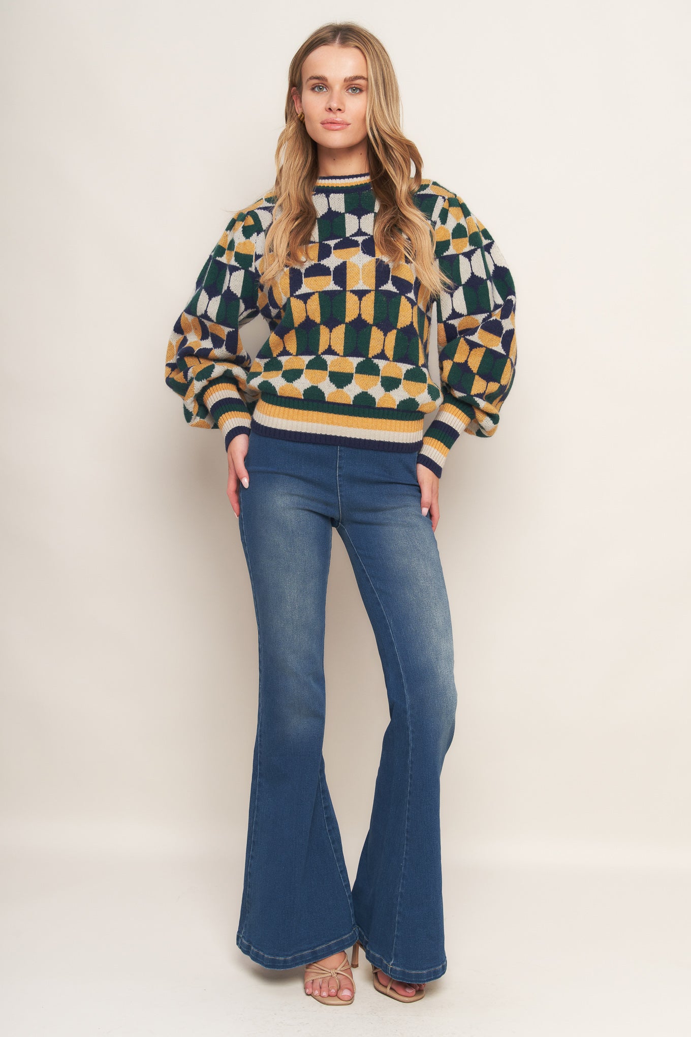 A jacquard knit sweater with a high neckline and long-sleeve