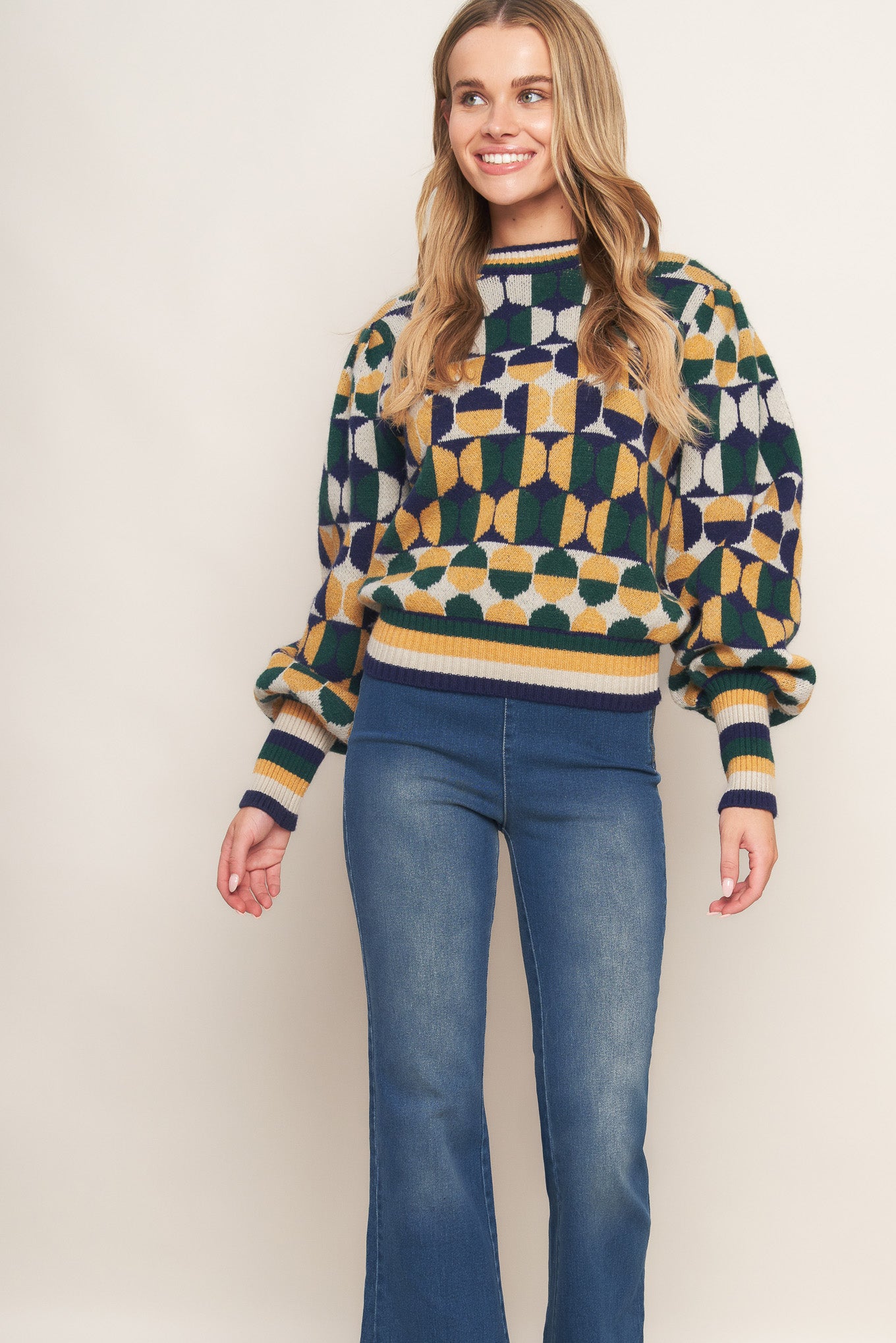 A jacquard knit sweater with a high neckline and long-sleeve